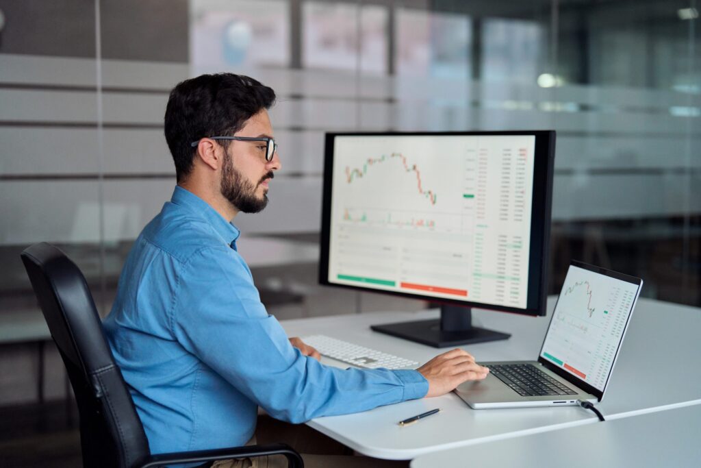 Financial advisors using modern financial tools, with a user-friendly dashboard displayed on the screen.